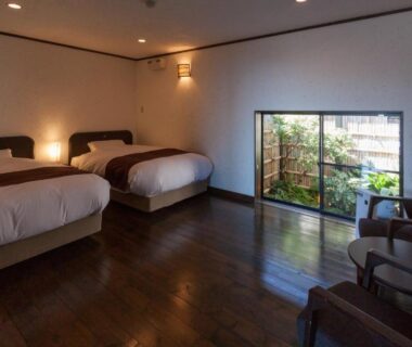 Twin room with hardwood floors, two beds and seating area overlooking small garden, Ito Yukitei Kawana Bettei, Shizuoka