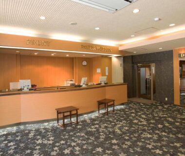 Reception desk and seating area in warm toned lobby at Itoen Hotel Shiobara in Tochigi Kantō