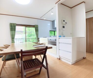 Bright open-plan dining and kitchen with balcony view at Itsukaichi First Villa Hiroshima, Chūgoku