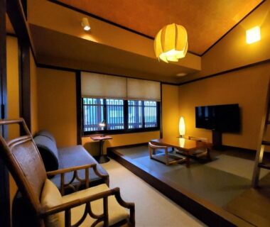 Tatami room with low table, sofa chairs, shoji window and ladder at Itsukushimahigashimonzen Kikugawa in Hiroshima