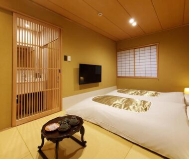 Tatami room with futons, shoji screens and low table at Itsukushimahigashimonzen Kikugawa Hiroshima