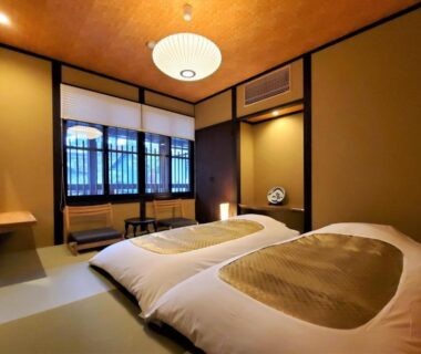 Traditional tatami room with futon bedding and shoji windows at Itsukushimahigashimonzen Kikugawa in Hiroshima