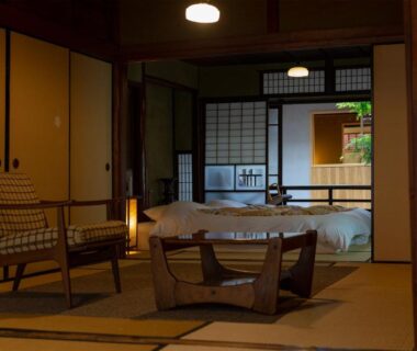 Traditional tatami room with futon bedding, low table and shoji screens at Itsumoya in Hiroshima