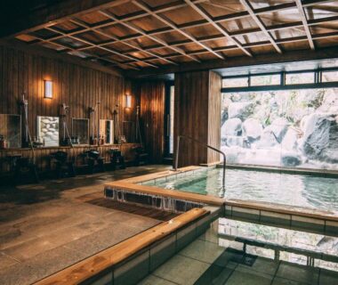 Indoor hot spring bath with wooden paneling and washing stations at Iwaiyado Jyuan Nikko Kawaji onsen in Tochigi, Kantō, Japan