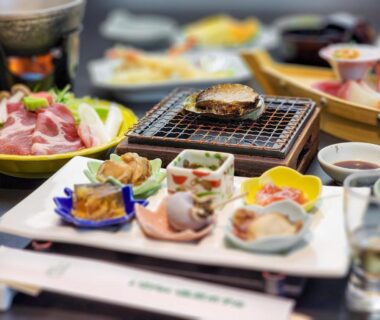 Assorted small Japanese dishes with tabletop grill at Iwanai Kogen Hotel in Hokkaidō