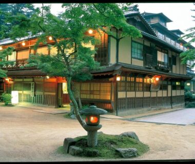 Stone lantern-lit courtyard outside Iwaso ryokan with traditional wooden architecture in Hiroshima Chūgoku