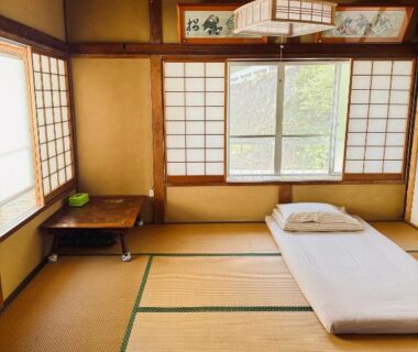 Tatami room with futon and shoji screens at Izu Hokkawa Seaside Guesthouse, Shizuoka
