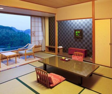 Traditional tatami room with low table, zabuton cushions and seating area facing mountain view at Izu-Nagaoka Hotel Tenbo, Shizuoka