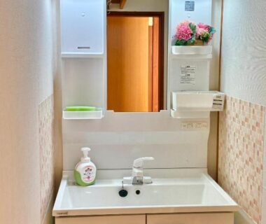 Small vanity sink with mirror and soap dispenser at Izu Shirada Villa in Shizuoka