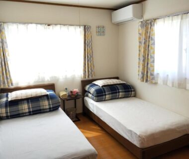 Twin beds with plaid bedding at Izu Shirada Villa, Shizuoka, Chūbu