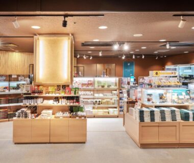 Interior ryokan gift shop at Izumigo AMBIENT Azumino Cottage with wooden display counters and shelves, Nagano