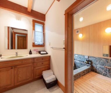 Wooden vanity and indoor soaking tub in a cottage at Izumigo AMBIENT Azumino, Nagano
