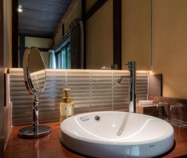 Round basin sink with mirror and toiletries at Ryokan Seryo, Kyoto