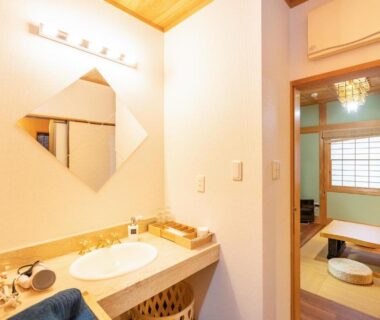 Washbasin and adjoining tatami room with shoji screens in Asakusa ryokan Tokyo