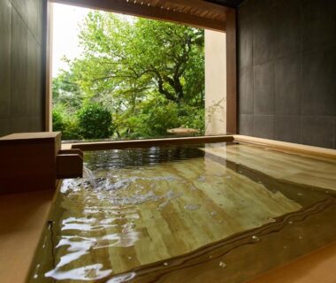 Wooden indoor onsen bath with garden view at Jinya Ryokan in Kanagawa