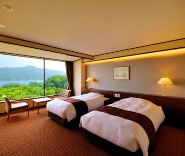 Twin beds with panoramic window overlooking coastal hills at Jodogahama Park Hotel Iwate Tohoku
