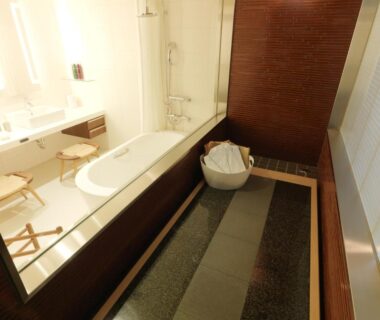 Wooden bathing area with separate modern tub and sink at Jozankei Tsuruga Resort Spa Mori no Uta in Hokkaido