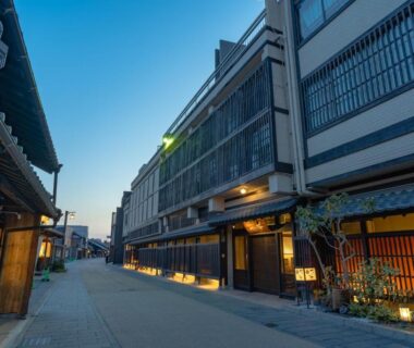 Narrow street of wooden ryokan facades at dusk, Juhachiro, Gifu in Chubu region