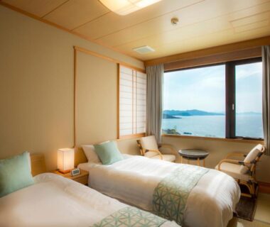 Twin beds, tatami flooring, large window overlooking coastal waters at Jukaitei, Kyoto