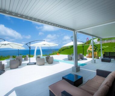 Covered terrace with sofas, parasols and sea view at Jukaitei, Kyoto