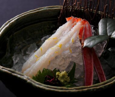 Crab sashimi on crushed ice in ceramic bowl with wasabi and greens, served at Jukaitei in Kyoto
