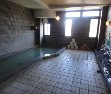 Tiled indoor communal bath with washing stations at Jukeiso, Hiroshima