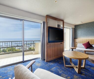 Lounge area with sliding doors and balcony overlooking sea at KAMENOI HOTEL Atami, Shizuoka, Chūbu Japan