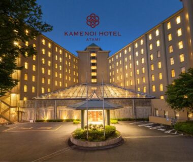 Lit hotel entrance with circular drive at KAMENOI HOTEL Atami in Shizuoka Japan