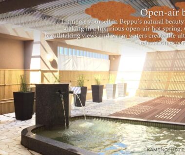 Stone onsen bath with wooden deck and bamboo screens at KAMENOI HOTEL Beppu, Ōita
