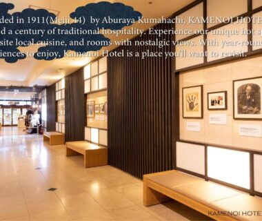 Lobby corridor with wooden slatted screens, benches and framed artwork at KAMENOI HOTEL Beppu, Oita