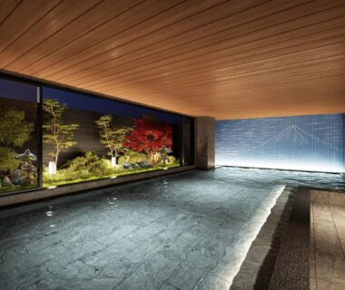 Indoor onsen with garden view and wooden ceiling at KAMENOI HOTEL Fuji in Yamanashi