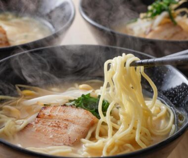 Steaming bowls of noodles with pork and greens at KAMENOI HOTEL Fuji in Yamanashi