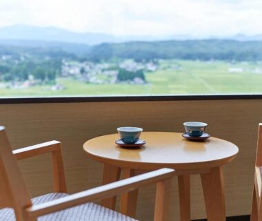 Two teacups on wooden table by window at KAMENOI HOTEL Ichinoseki, Iwate