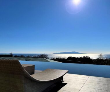 Sunlit infinity pool terrace overlooking the sea at KAMENOI HOTEL Izukogen, Shizuoka