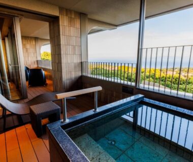 Room balcony soaking tub with wood deck and seating, coastal view at KAMENOI HOTEL Izukogen Shizuoka