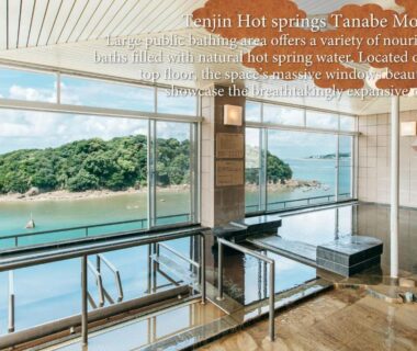 Indoor onsen bath with panoramic windows overlooking a coastal bay at KAMENOI HOTEL Kii-Tanabe, Wakayama