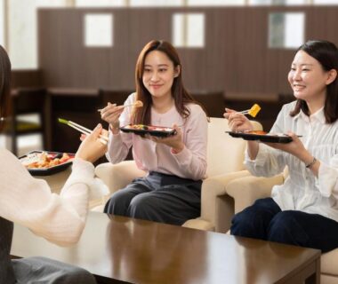 Three guests sharing tray meals in a ryokan lounge at KAMENOI HOTEL Okunikko, Tochigi, Kantō, Japan