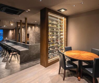 Interior bar and dining area with counter seating and wine rack at KOS Restaurant & Hotel, Yamanashi