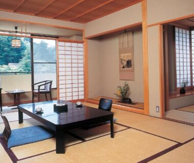 Tatami room with low table, zabuton cushions and tokonoma alcove at Kadonobo Ryokan in Hyōgo, Kansai