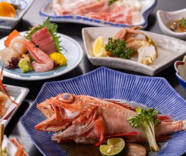 Whole fish and sashimi with assorted side dishes at Kagariya ryokan in Hokkaidō