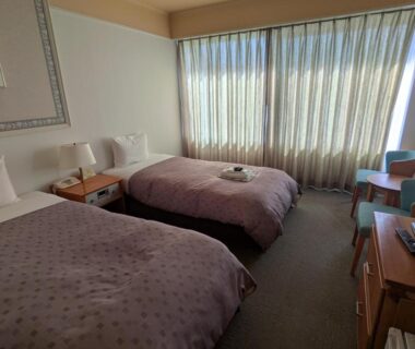 Twin beds with bedside table and desk in Kagetsuen room, Kanagawa, Kantō