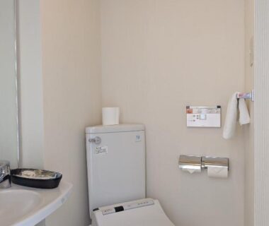 Compact restroom with bidet toilet and sink at Kagetsuen in Kanagawa, Kantō, Japan