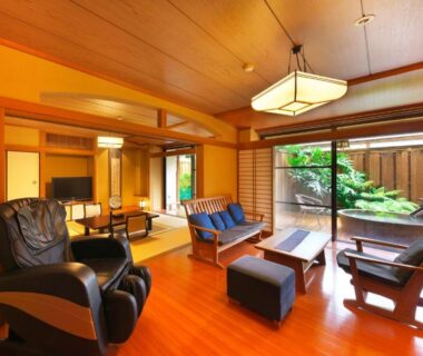 Lounge and tatami area with sliding doors to a small garden at Kagetsutei, Shizuoka, Japan