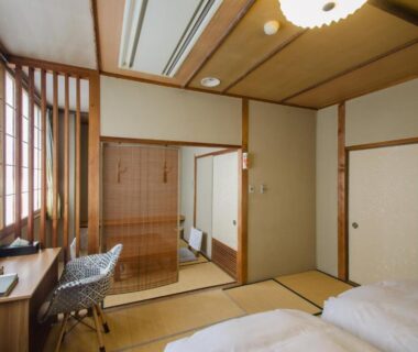 Traditional tatami room with futon bedding, shoji screens and wooden desk at Kaigetsu in Mie, Kansai