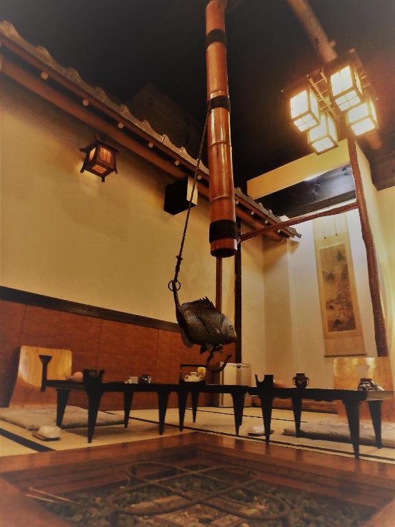 Irori Hearth Dining at Kaigetsu Mie Irori hearth with suspended kettle and low tables in Kaigetsu ryokan, Mie, Kansai