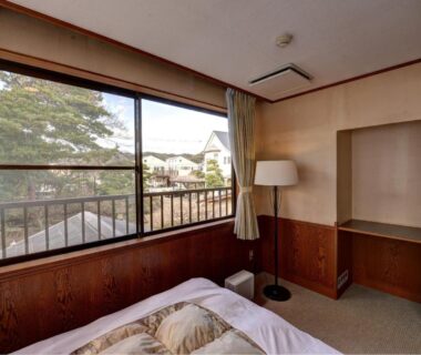 Bedroom with large window and neighborhood view at Kaihinsou Kamakura, Kanagawa, Japan