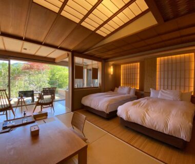 Tatami room with futon beds, shoji screens and garden view at Kaiseki Ryokan Ashikari in Kanagawa