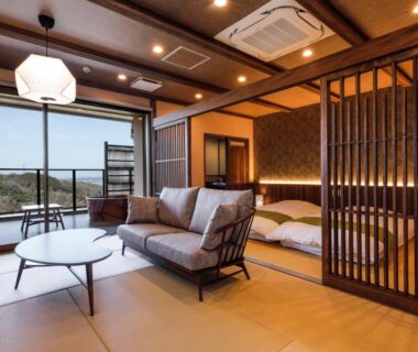 Tatami room with sofa, low table, shoji screens and balcony at Kakimotoya in Nara, Kansai