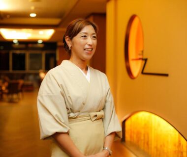 Smiling attendant in kimono in warm corridor at Kakimotoya in Nara, Kansai