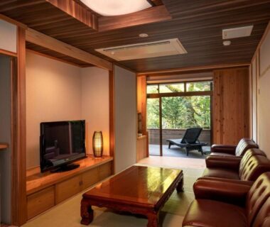 Tatami room with low table, leather seating and garden view at Kakureisen, Saga, Kyūshū